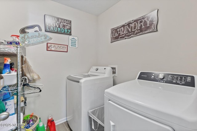 laundry room with washer and dryer and hardwood / wood-style floors