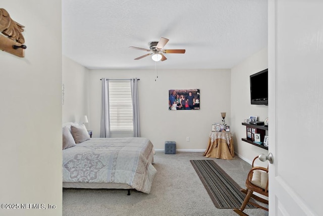 bedroom featuring ceiling fan and carpet