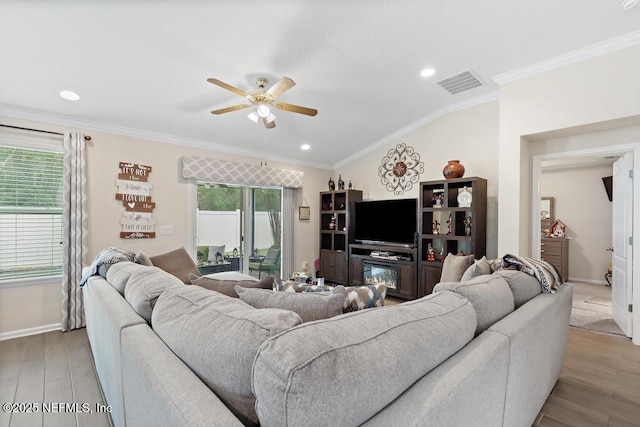 living room featuring ceiling fan, light hardwood / wood-style floors, and crown molding