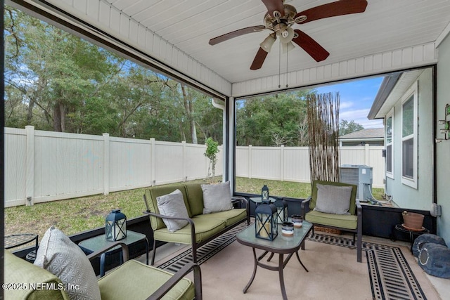 sunroom / solarium featuring ceiling fan