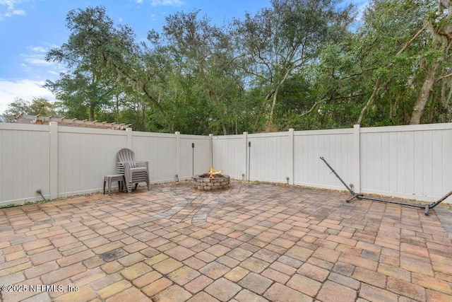 view of patio / terrace featuring an outdoor fire pit