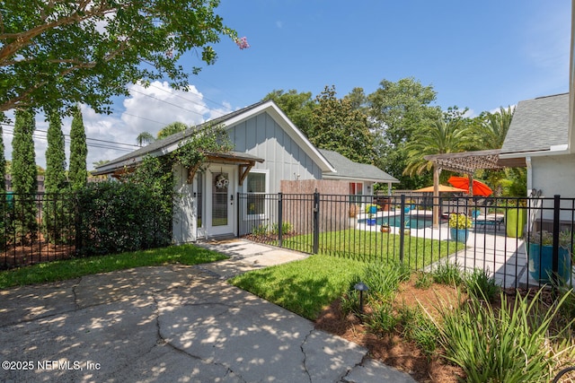 exterior space featuring a fenced in pool, a front lawn, and a patio