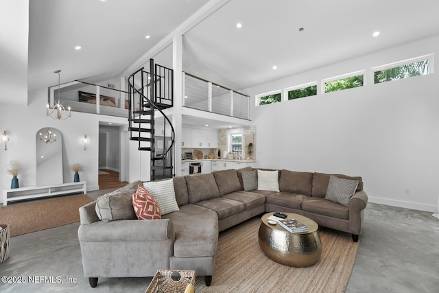 living room featuring a towering ceiling and a chandelier