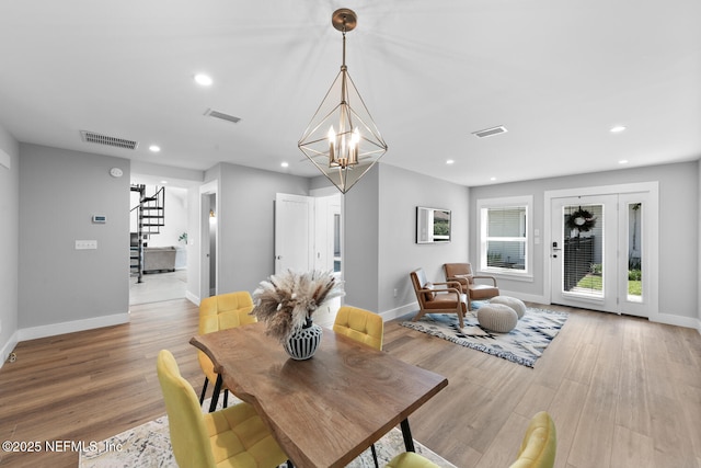 dining room with a chandelier and light hardwood / wood-style flooring