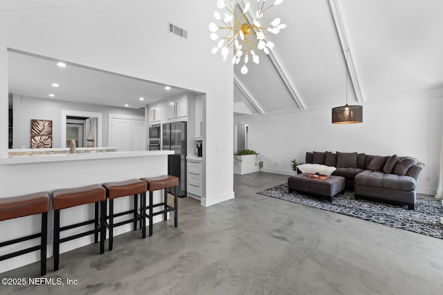 living room featuring lofted ceiling, sink, concrete floors, and an inviting chandelier