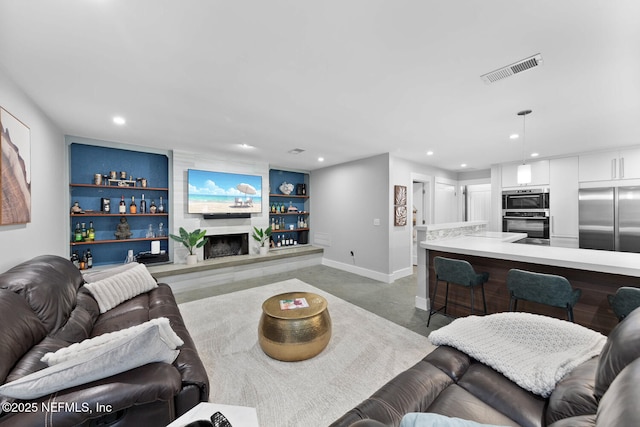 living room with built in features and concrete floors