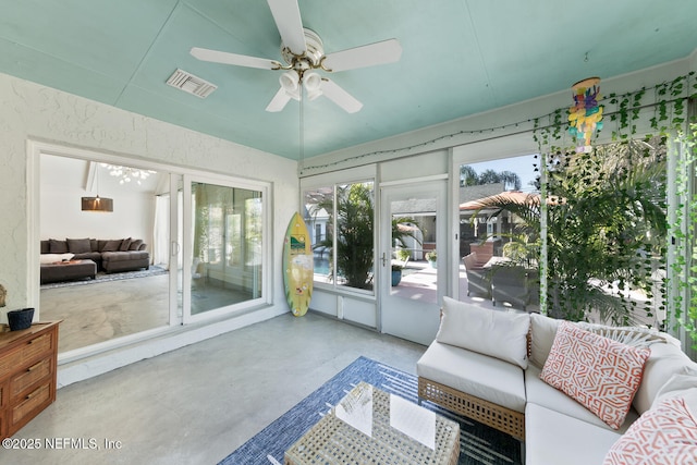 sunroom / solarium featuring ceiling fan