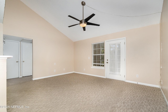 carpeted spare room featuring ceiling fan and high vaulted ceiling