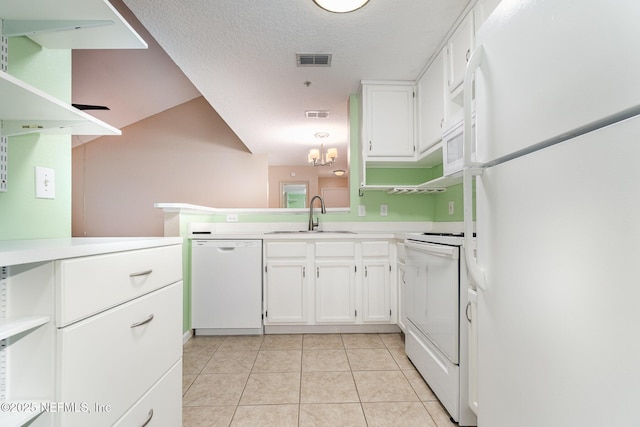 kitchen with sink, kitchen peninsula, a textured ceiling, white appliances, and white cabinets