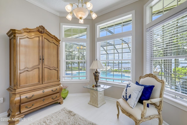 sitting room with crown molding and a chandelier