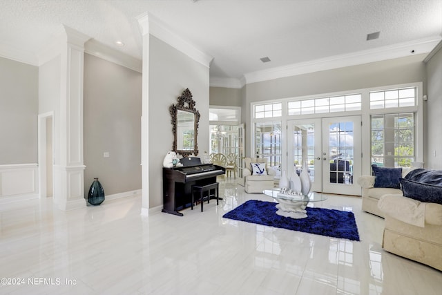 living room featuring ornate columns, ornamental molding, a textured ceiling, and french doors