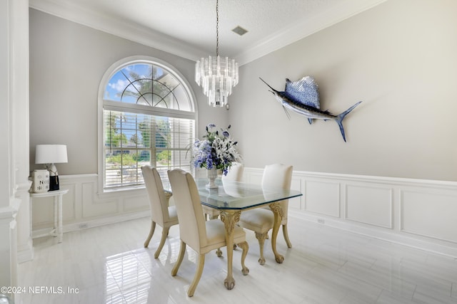 dining room with a chandelier, a textured ceiling, and crown molding