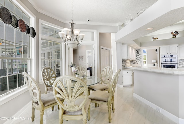 dining room featuring ornamental molding, a textured ceiling, and a notable chandelier