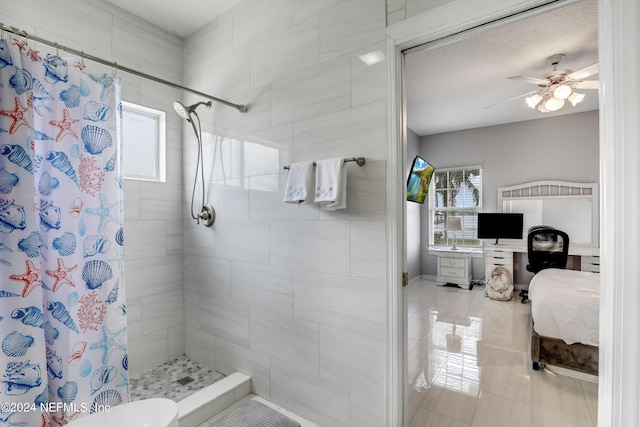 bathroom with ceiling fan, curtained shower, toilet, and a textured ceiling