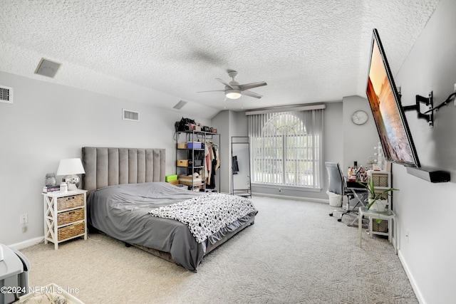 carpeted bedroom with a textured ceiling, ceiling fan, and lofted ceiling