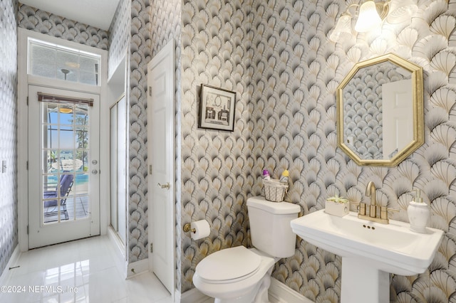 bathroom with sink, tile patterned flooring, and toilet