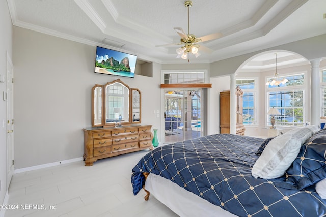 bedroom with access to outside, ceiling fan with notable chandelier, crown molding, a textured ceiling, and a tray ceiling