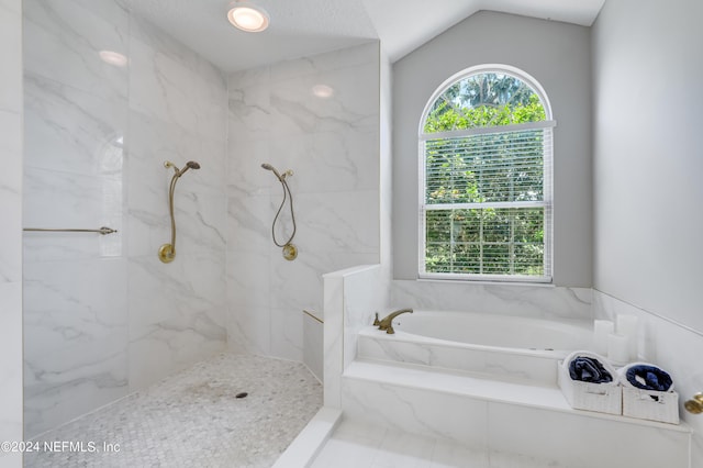 bathroom featuring shower with separate bathtub and vaulted ceiling