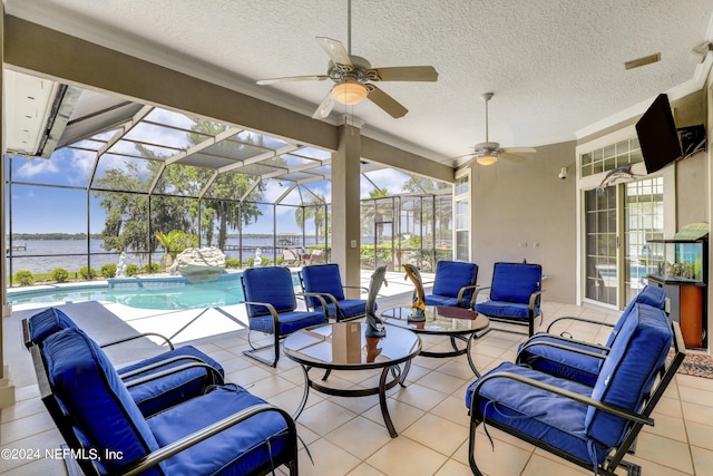 view of patio / terrace with outdoor lounge area, a water view, glass enclosure, and ceiling fan