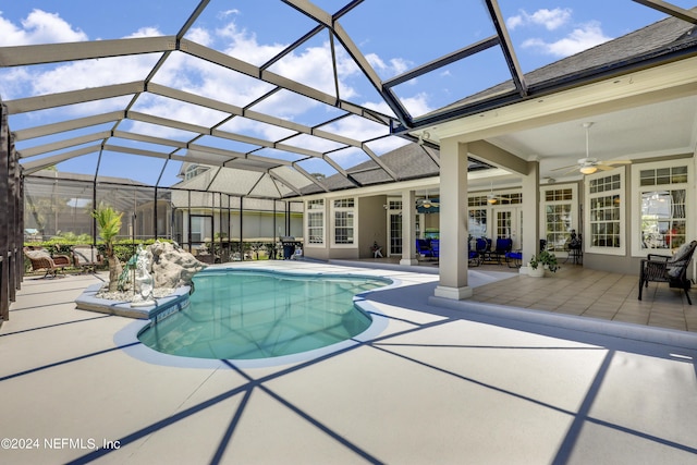 view of swimming pool featuring a lanai, a patio area, and ceiling fan