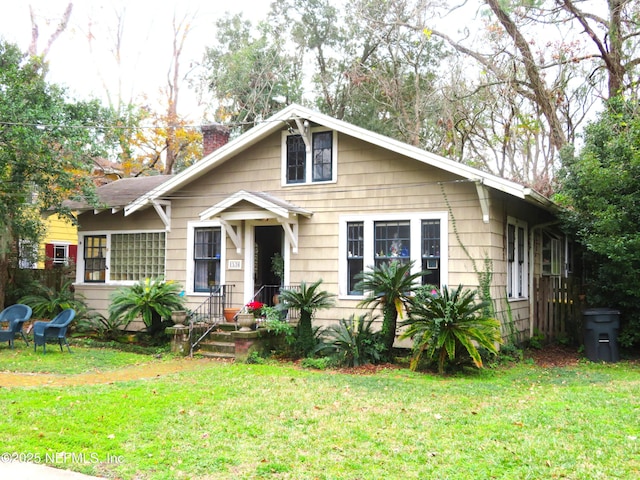 bungalow-style house with a front lawn