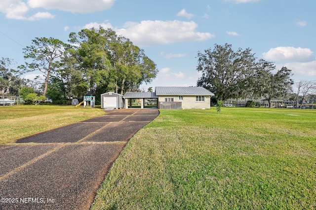 single story home featuring a front lawn and a playground