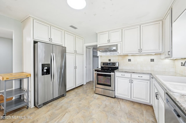 kitchen featuring exhaust hood, white cabinetry, stainless steel appliances, backsplash, and sink