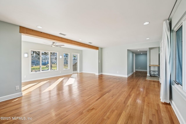 unfurnished living room with ceiling fan, beam ceiling, and light wood-type flooring