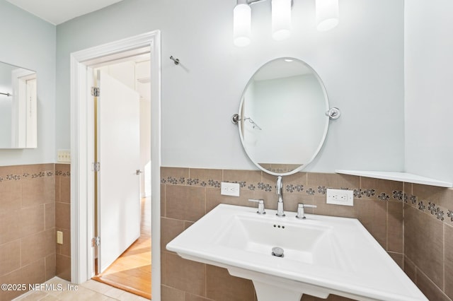 bathroom with sink, tile walls, and tile patterned floors