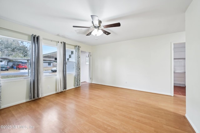 spare room with light wood-type flooring and ceiling fan