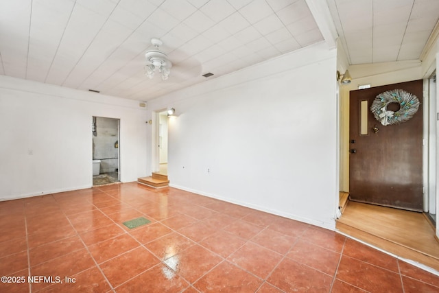 tiled empty room with ceiling fan