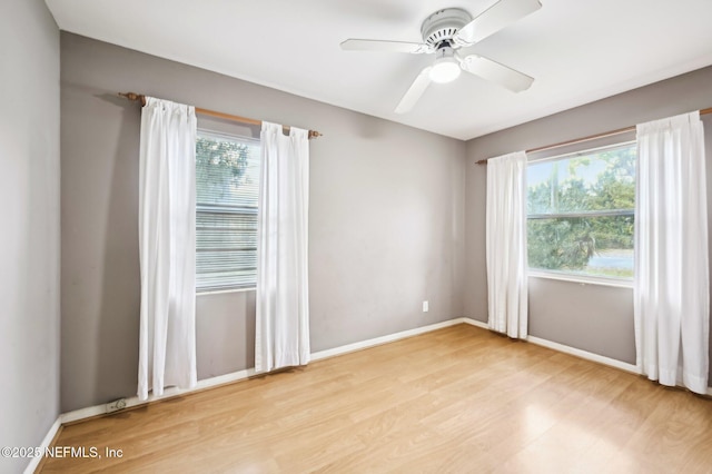 empty room featuring ceiling fan and light hardwood / wood-style floors