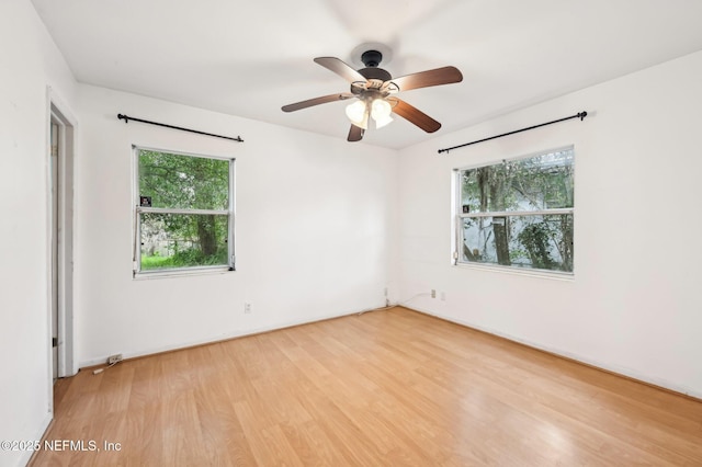 empty room featuring light hardwood / wood-style floors, plenty of natural light, and ceiling fan