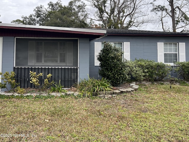 view of side of property with a yard