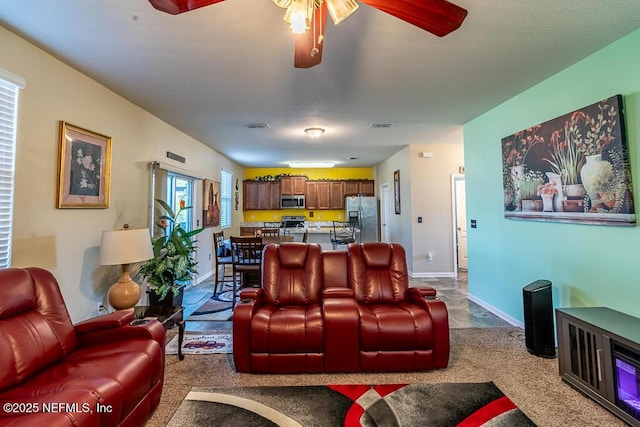 living room with carpet flooring and ceiling fan