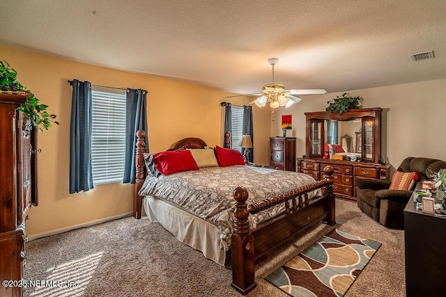 bedroom featuring carpet flooring, a textured ceiling, and ceiling fan