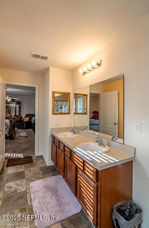 bathroom featuring vanity and a textured ceiling