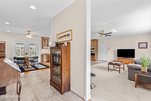 carpeted living room featuring ceiling fan and french doors