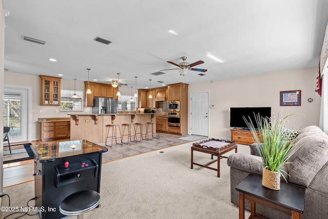 carpeted living room featuring ceiling fan