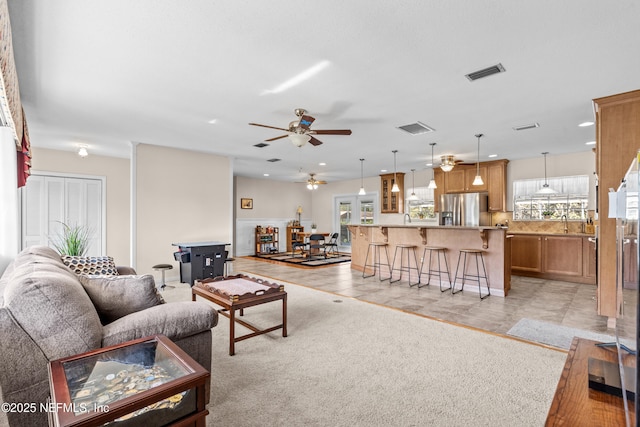 tiled living room featuring sink