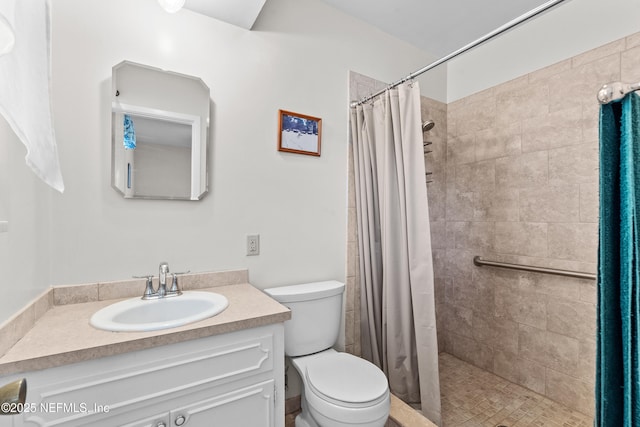 bathroom with vanity, toilet, and walk in shower