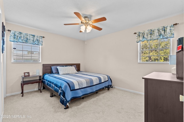 carpeted bedroom with ceiling fan and multiple windows