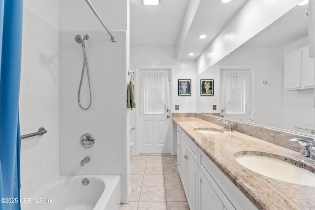 full bathroom with toilet, vanity, tiled shower / bath combo, and tile patterned floors