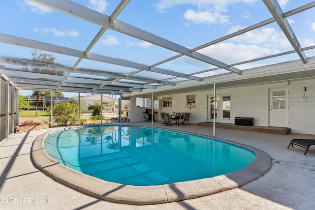 view of swimming pool featuring a lanai and a patio