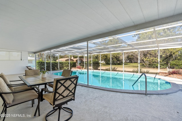 view of swimming pool featuring glass enclosure and a patio