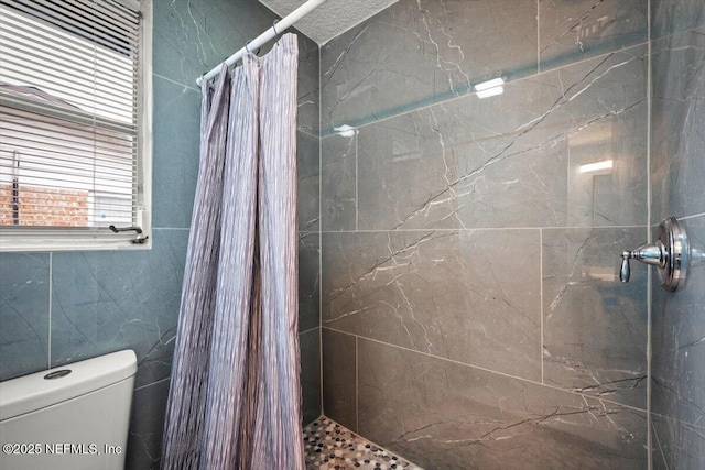 bathroom with toilet and curtained shower