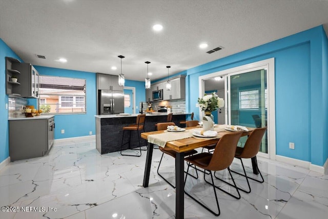 dining area with a textured ceiling