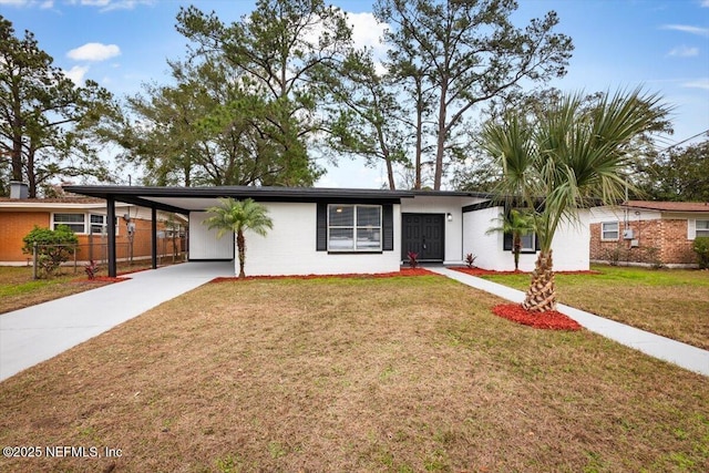 ranch-style house with a front yard and a carport