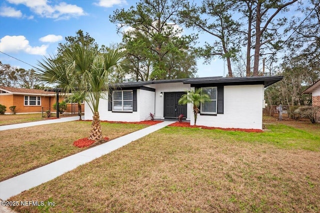 ranch-style home with a front lawn