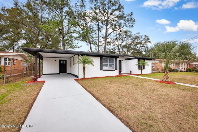 ranch-style house with a front yard and a carport